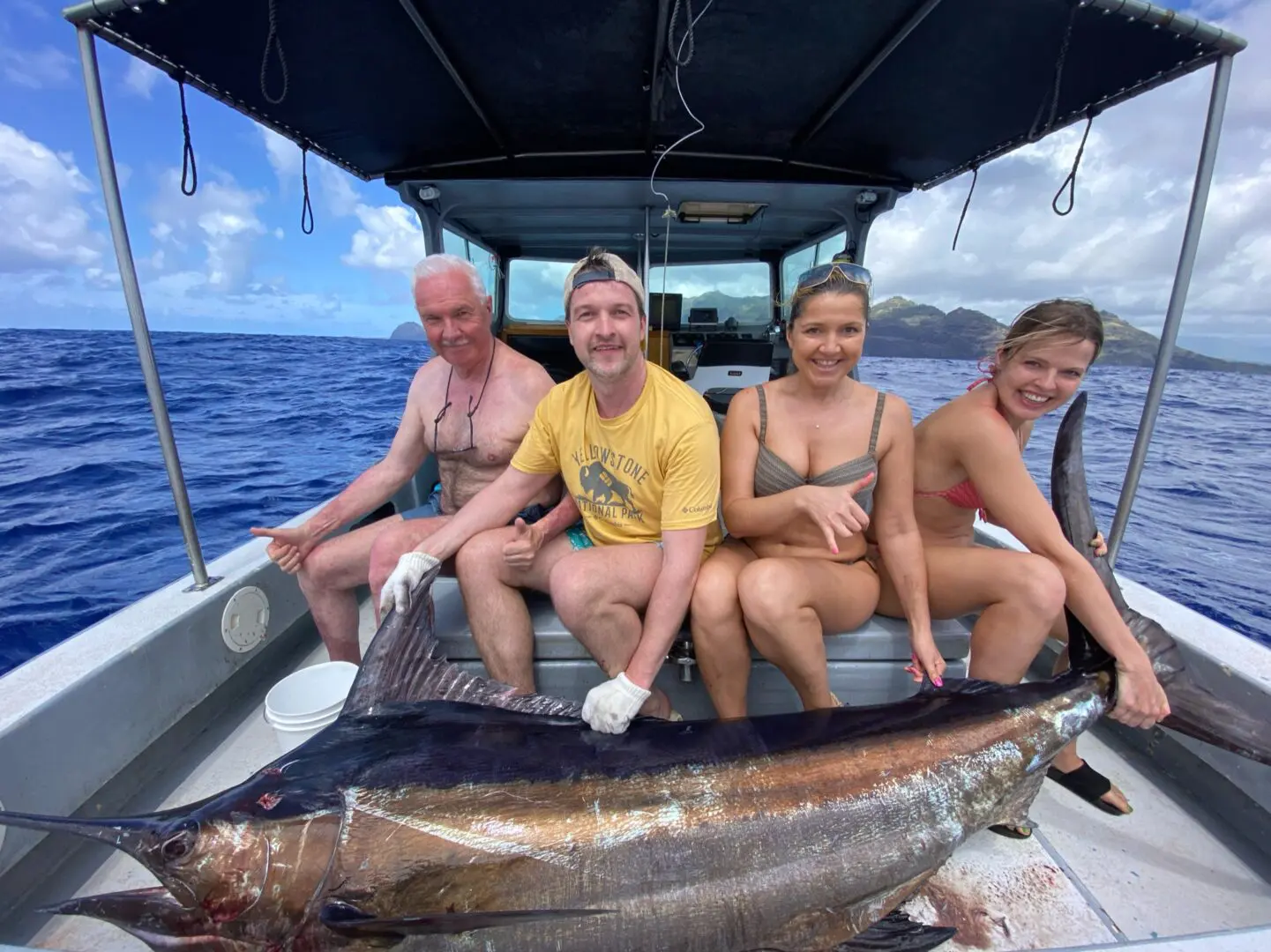 A group of people sitting on the back of a boat.